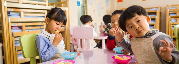 Three Toddler Eating on White Table